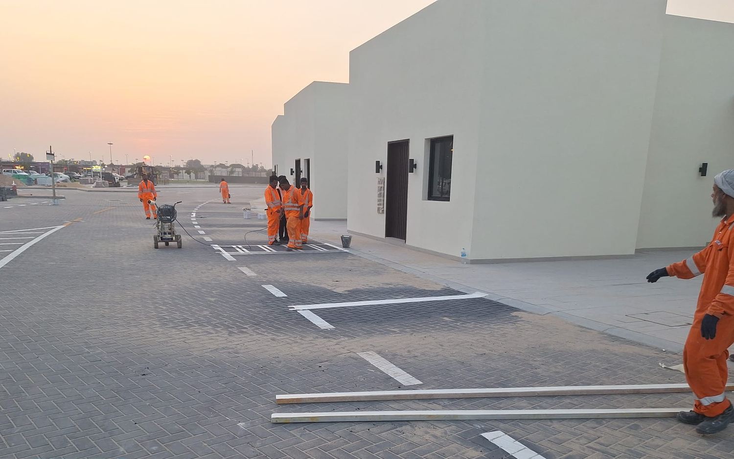Al Moizz crew line-marking the completed parking areas at Ariane District 1