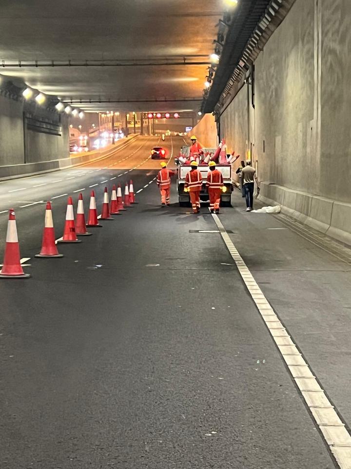 Crew placing cones inside a road tunnel