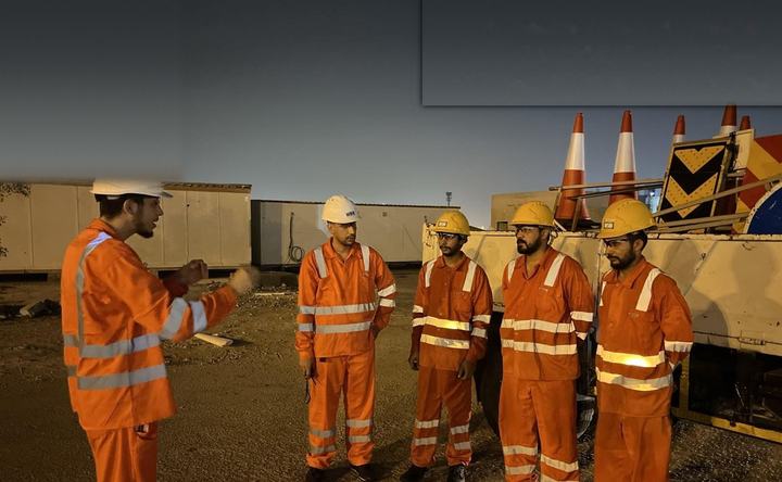 Crew briefing beside a TMA and chevron boards