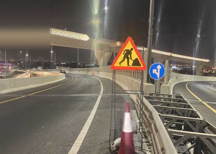 Roadworks warning sign on a cone-protected stand
