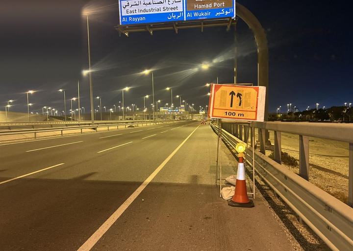 Lane-closure sign beneath an overhead gantry