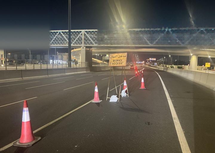 Cone taper approaching a pedestrian bridge