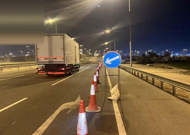 Keep-left sign and cones beside a live lane