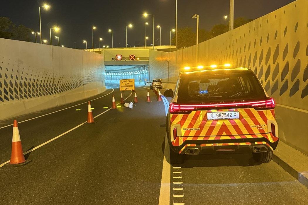 Road works support vehicle escorting works inside a Doha underpass
