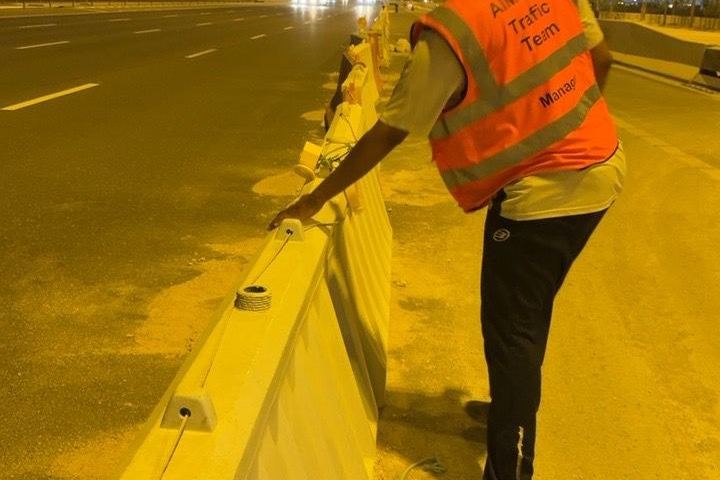 Al Moizz traffic team member setting barriers along a carriageway