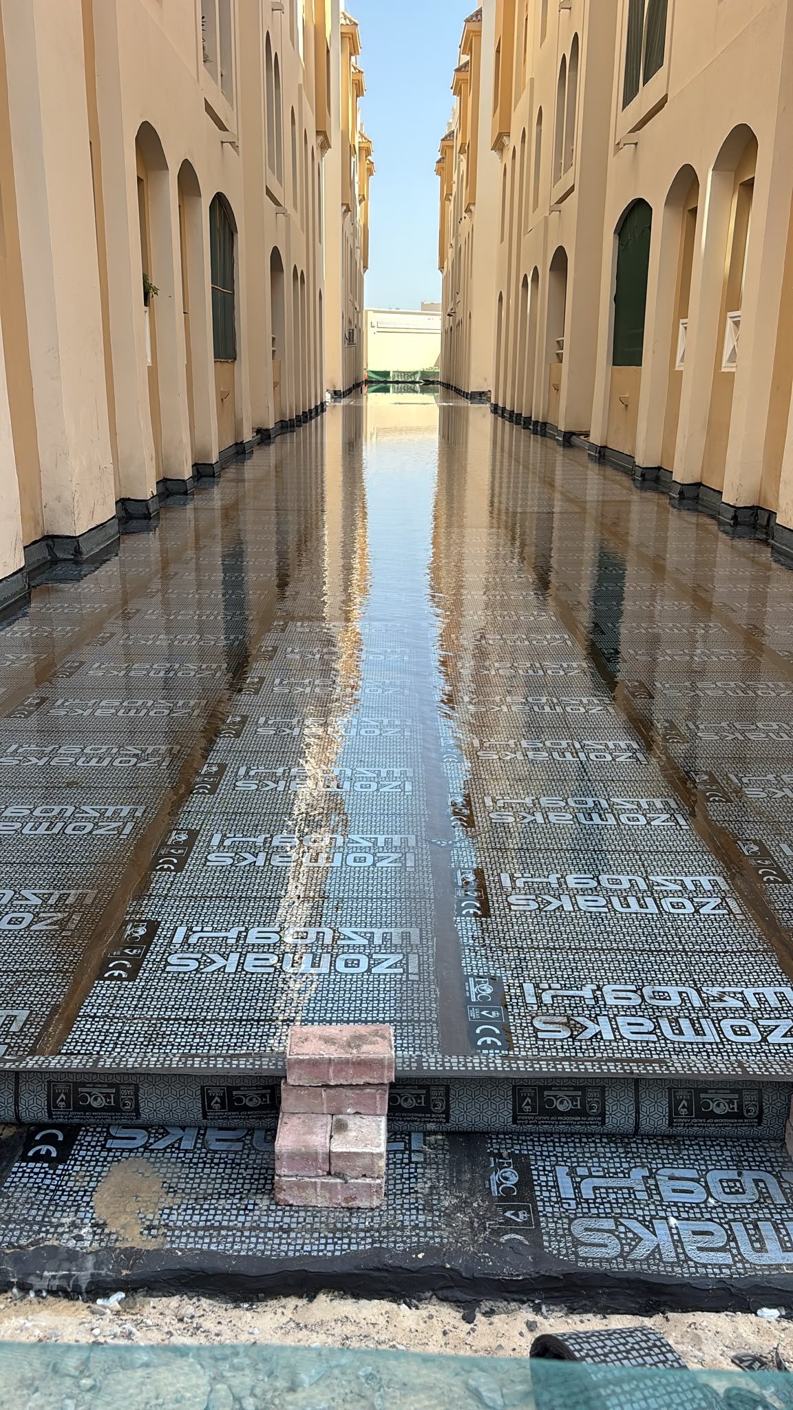 Glossy waterproofed flooring along a service alley